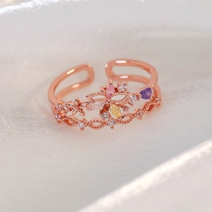 Detail of rose gold double-layer open ring featuring zircon flower and butterfly motifs