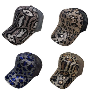 Detail showing four colors of sequin leopard print trucker hats with mesh back for women