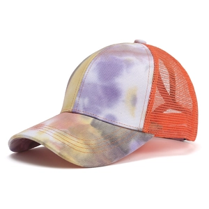 Detail of colorful tie-dye baseball cap featuring purple gradient and orange mesh back