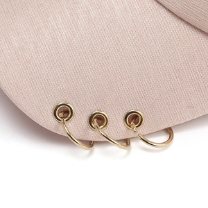 Pale pink cotton baseball cap with three gold metal rings on the brim for street fashion