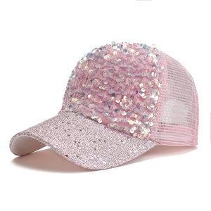 Detailed side view of pink sequin trucker hat with glittery brim and breathable mesh