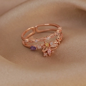 Macro shot of rose gold adjustable ring with colorful zircon floral design on champagne velvet