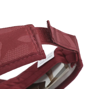 Detail view of the adjustable velcro strap and textured jacquard fabric of the visor hat
