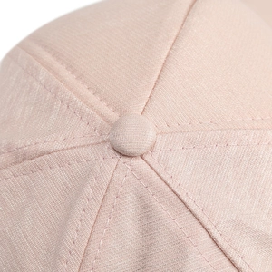 Pale pink baseball cap with metal ring detail showing premium fabric texture and stitching