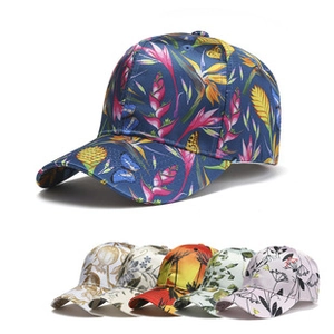 Close-up of baseball cap featuring tropical floral prints and butterfly patterns