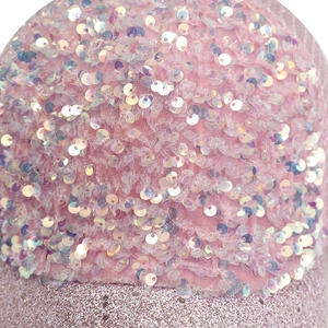 Close-up of pink sequin details and glitter fabric texture on the stylish baseball cap