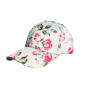 Women's stylish white baseball cap with pink rose floral pattern shown at a 45-degree angle