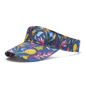 Detail of dark blue sun visor hat with tropical butterfly and floral print texture
