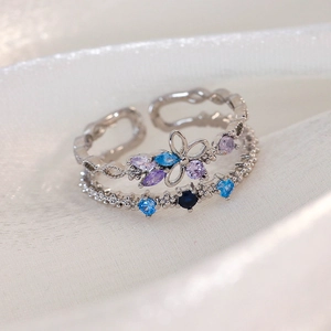 Detail of silver double-layered open ring with purple and blue zircon floral stones