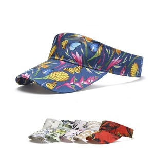 Detail showcasing various floral and butterfly prints on adjustable sun visor hats