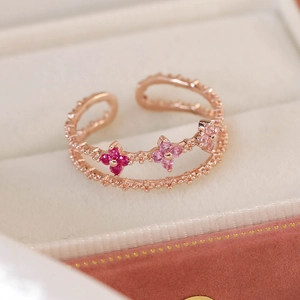 Detail of rose gold open ring featuring double bands and three micro-set zircon flowers