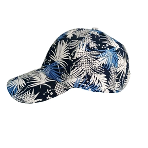 Detail of navy baseball cap with white and light blue tropical palm leaf print