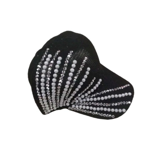 Detailed view of women's black knit baseball cap with rhinestone and pearl fan pattern
