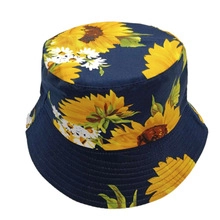 Detailed view of sunflower print on dark blue cotton reversible bucket hat fabric