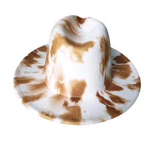 Close-up of fine stitching and brown cow-print tie-dye on a white wool fedora hat