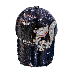 Close-up of sparkling rhinestone fox pattern and black sequins on a women's baseball cap