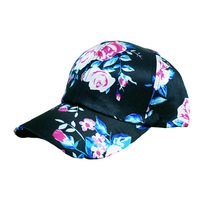 Detailed view of women's hollow baseball cap with pink rose floral pattern on black fabric
