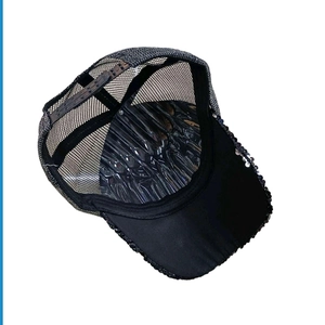 Detail of sequined baseball cap showing breathable mesh back and adjustable strap buckle