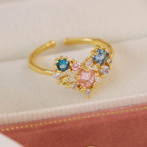 Macro shot of gold heart ring with multicolor zircon stones in a velvet box