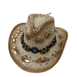 Détail du chapeau de cowboy en paille ajourée avec perles ethniques et pierre bleue