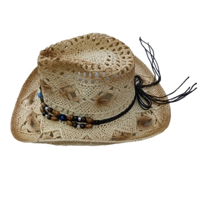 Détail du chapeau de cowboy en paille avec tissage ajouré, perles en bois et accents bleus