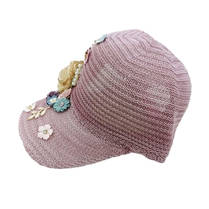 Detailed close-up of light purple mesh knit cap with decorative fabric flowers and pearls
