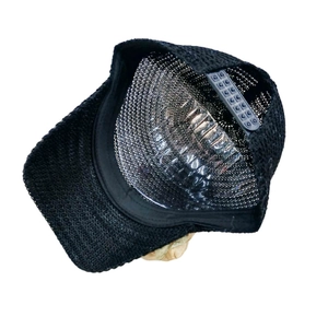 Detail of breathable black mesh cap showing internal structure and adjustable snap closure