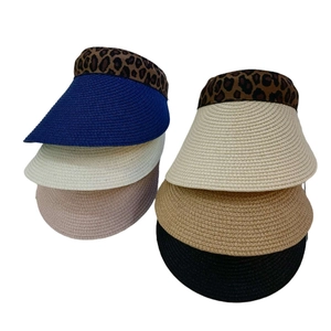 Detailed weave of sun visors with leopard print trim in multiple vibrant colors
