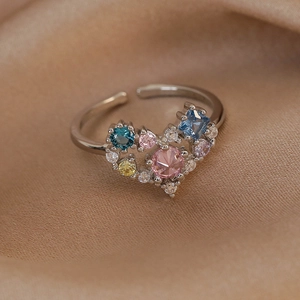 Macro detail of adjustable silver ring with colorful zircon heart-shaped gemstone cluster