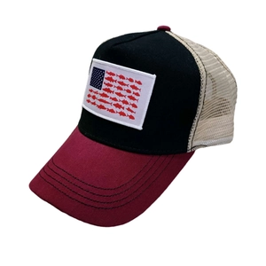 Detail of creative American flag fish patch on a mesh trucker hat with contrast stitching