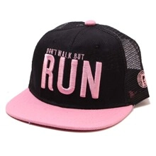 Close-up of pink embroidered lettering on a black canvas and mesh baseball cap