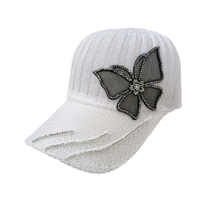 Detail of white knit baseball cap with rhinestone mesh butterfly and sparkly wavy lines
