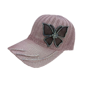 Detailed view of rhinestone butterfly and decorative crystal stripes on a pink baseball cap