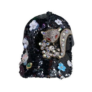 Detailed close-up of a black sequin baseball cap featuring a 3D floral and fox motif