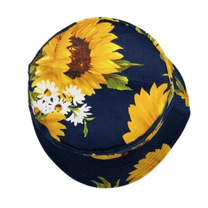 Top view of navy cotton bucket hat with bright yellow sunflower and daisy floral patterns