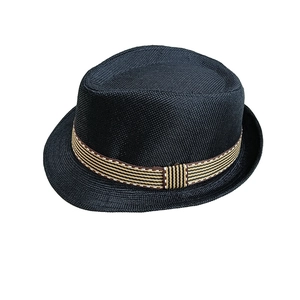 Close-up of black woven straw hat with brown striped ribbon detail and mesh texture