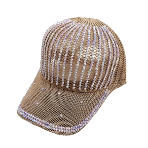 Detail of breathable knitted baseball cap with iridescent rhinestones in earthy brown tone