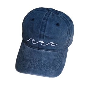 Navy blue washed cotton baseball cap featuring minimalist white wave embroidery