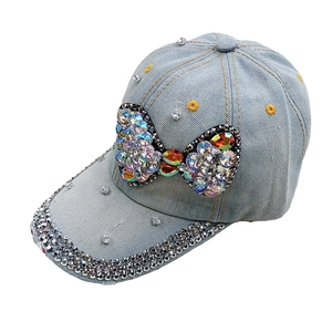 Blue denim baseball cap with a large crystal butterfly bow and sparkling rhinestones