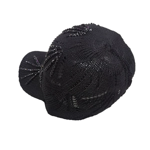 Close-up of black breathable knit baseball cap with sequin leaf patterns on the side