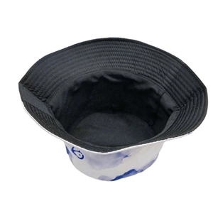 Detail of reversible bucket hat showing blue ink wash print and black inner lining