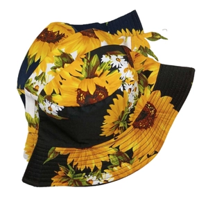 Detailed view of sunflower print patterns on cotton sun hats in black and navy