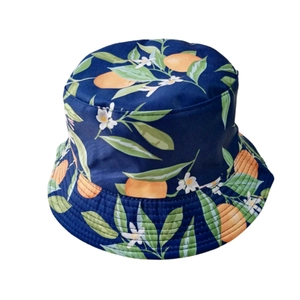 Detail of navy blue bucket hat with vibrant orange fruit and green leaf patterns