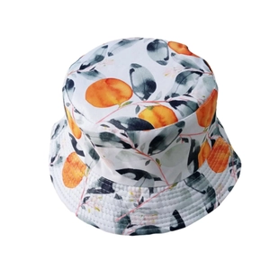 White bucket hat featuring tropical orange and leaf print for summer sun protection