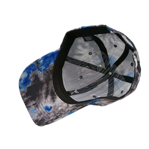 Unisex tie-dye baseball cap in blue and grey showing internal sweatband and metal buckle