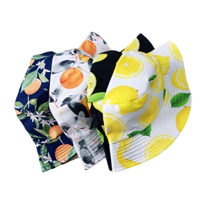 Detail view of summer bucket hats featuring tropical fruit prints in four vibrant colors
