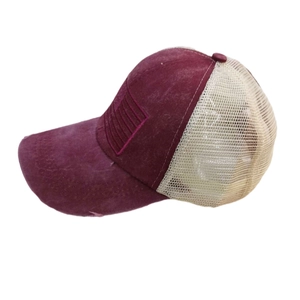 Close-up of vintage washed trucker hat with breathable mesh and distressed brim details