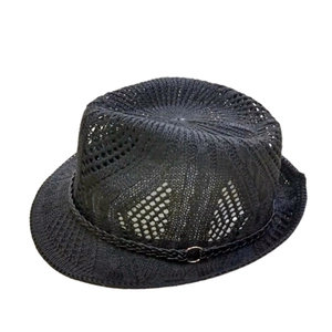 Detail of black knit fedora hat with breathable holes and silver metal buckle accent