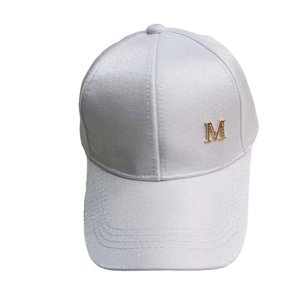 Detail of silver satin baseball cap with rhinestone M badge and smooth glossy finish
