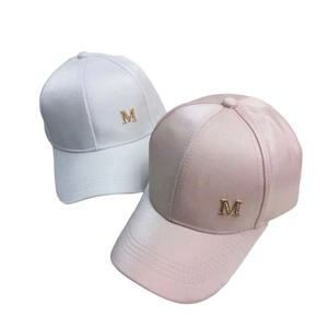 Close-up of satin silk baseball caps in white and pink with rhinestone M buckle